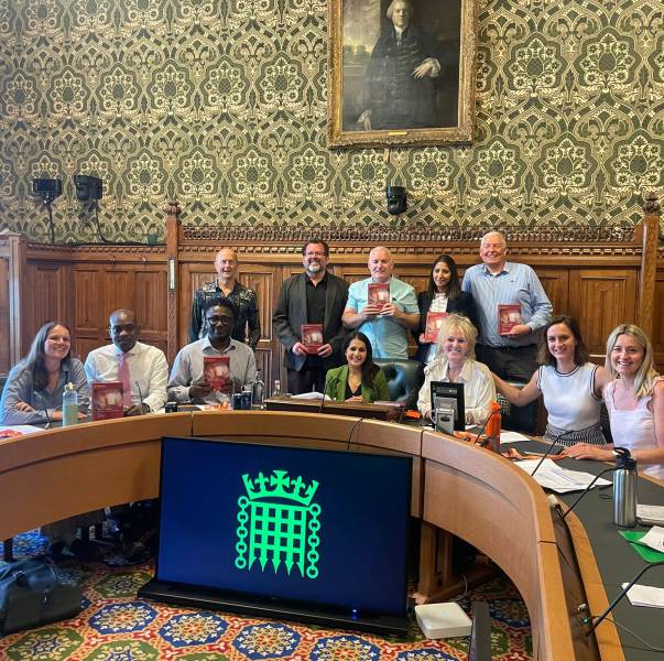 Group of people sat in Parliament
