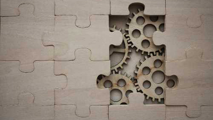 Wooden cogs and jigsaw pieces