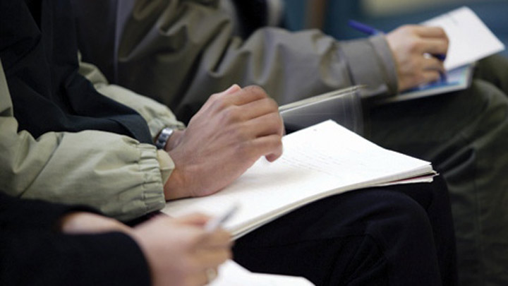 delegates taking notes at an event