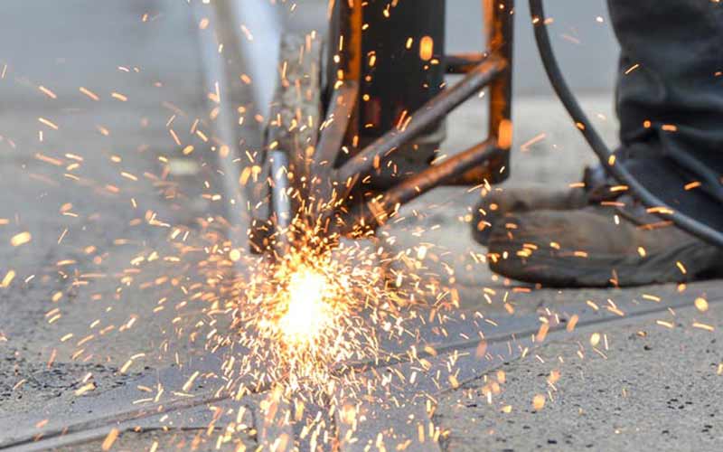 Sparks from an angle grinder cutting paving slabs