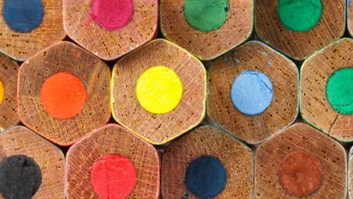 The top end of many coloured pencils forming a collage