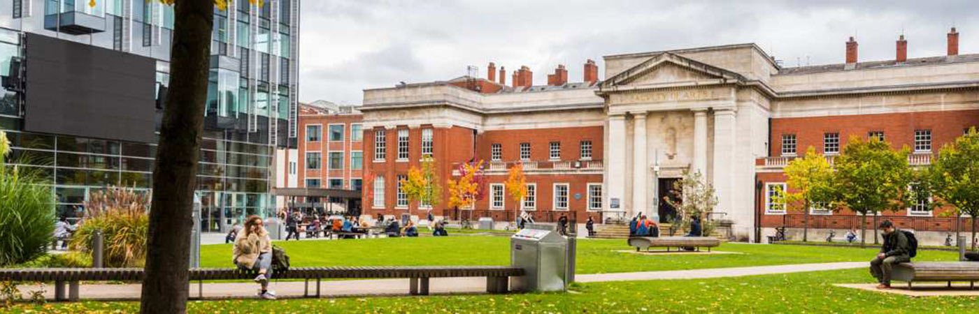 Students on lawn outside Samuel Alexander Building and Alan Gilbert Learning Commons, Manchester.