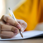 A hand holding a pen