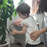 Mother and child watering a plant