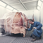 Man spray painting a car