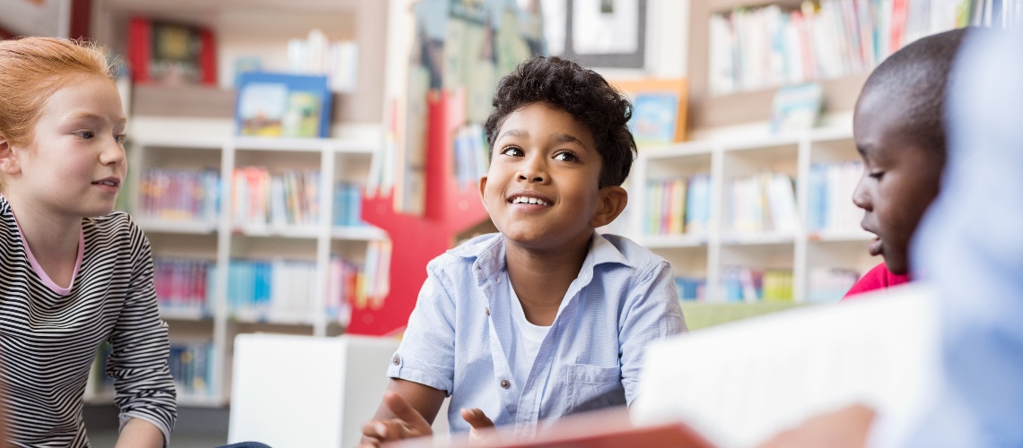 Three young children in a learning environment.