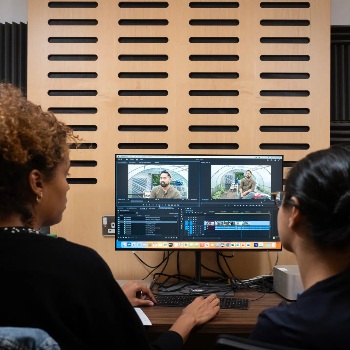 Two women looking at a computer screen.