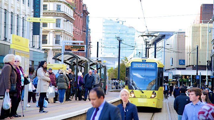 People waiting at a tram stop in Manchester 