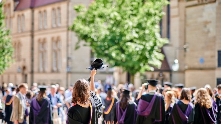 Graduating students outside the University of Manchester.
