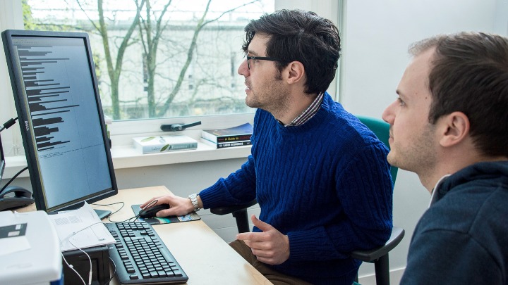 Academics analysing data on a computer screen