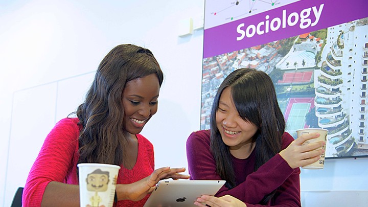 Pair of students looking at an ipad