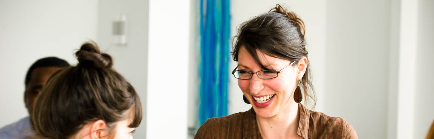 A student laughing at a PGR Conference