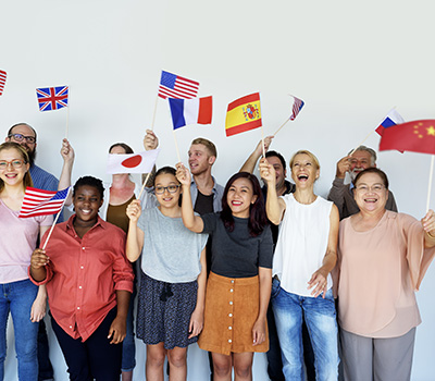 Diverse group holding international flags, celebrating cultures and global communities.