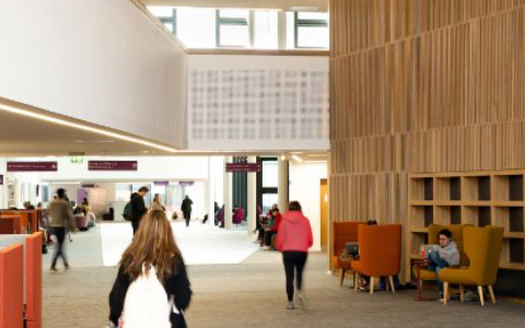Students walking in AMBS building
