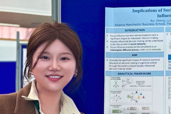 Student stood near a notcie board
