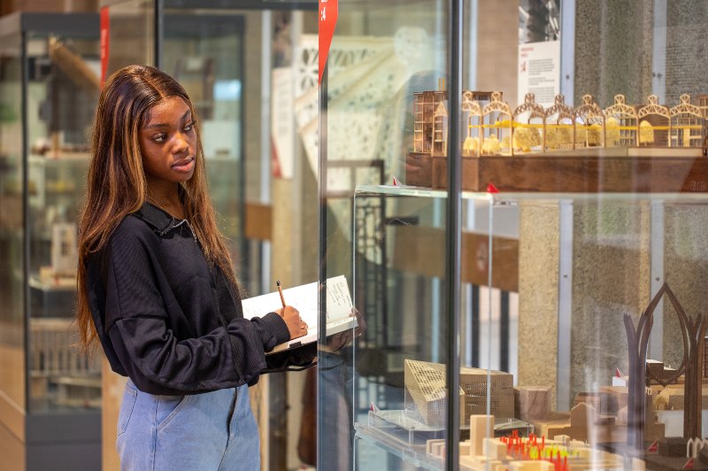Student looking at architecture exhibits. 