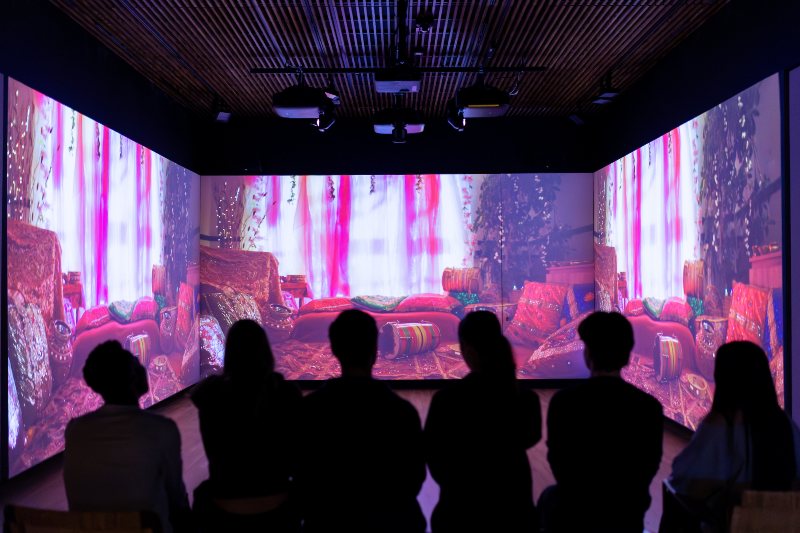 Students watching moving art on a screen