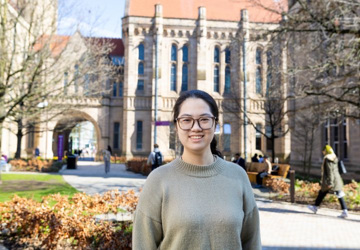 Student standing in the university gardens