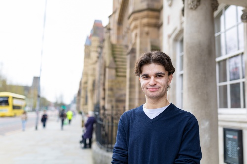 Student standing on Oxford Road in Manchester