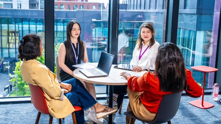 Students in discussion around a table 