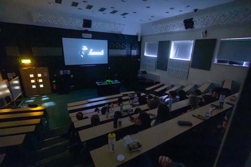 A film screening in a lecture theatre. 
