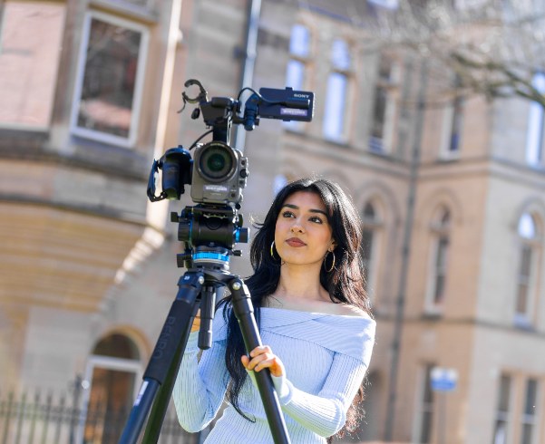 Students using a camera on the campus