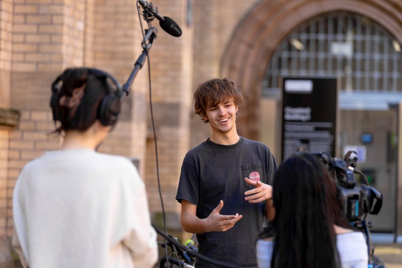 Students filming on campus. 
