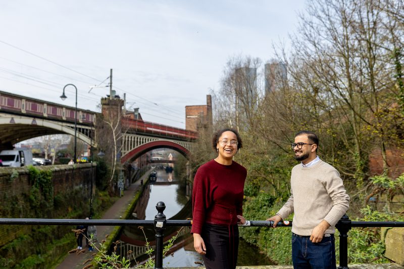Students in discussion at a Manchester canal, illustrating how philosophy lives in conversation