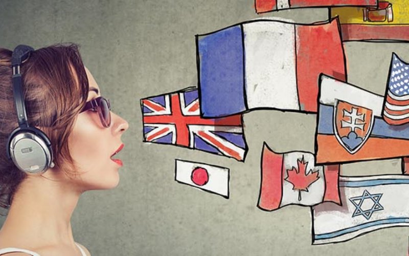 A man and a woman with headphones on are separated by different flags