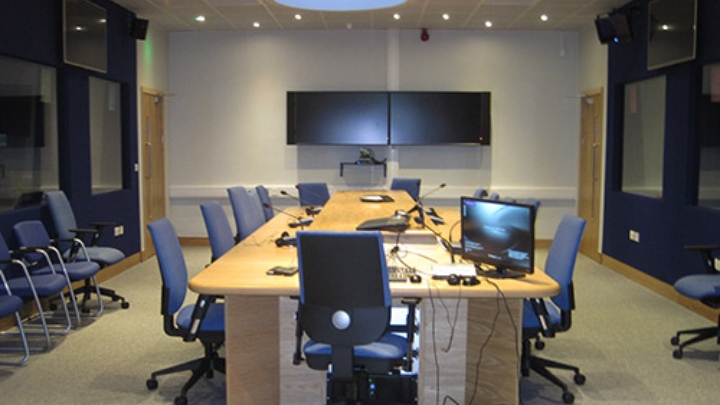 a room with microphones and screens